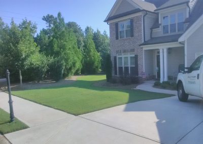 A white house with a nice lawn in front of it