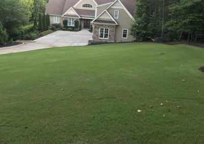 A house with a large yard and trees.
